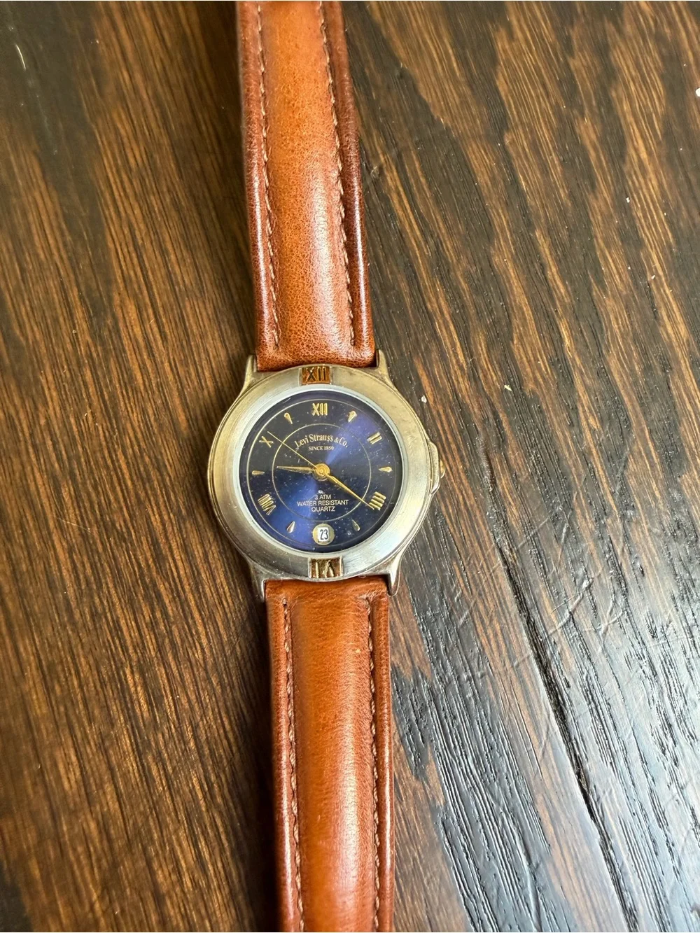 Vintage Levi’s quartz watch with a dark blue dial and a brown leather strap.